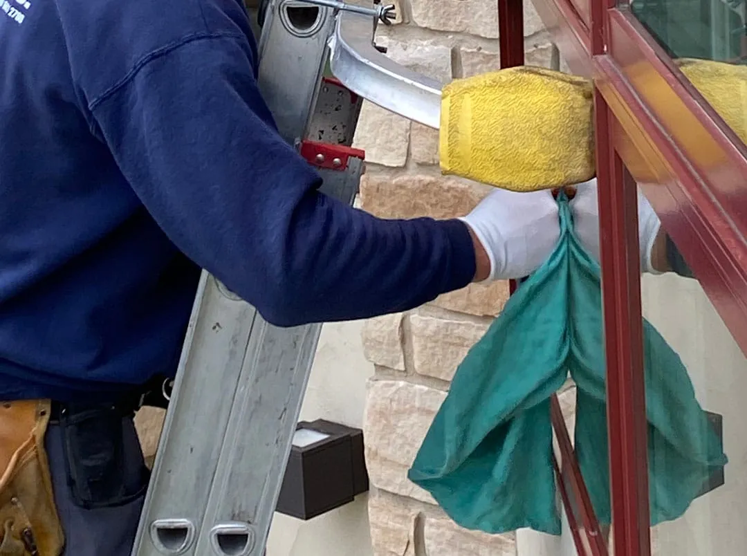 window washer on the ladder cleaning residential windows