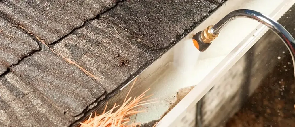 gutter being cleaned by hose