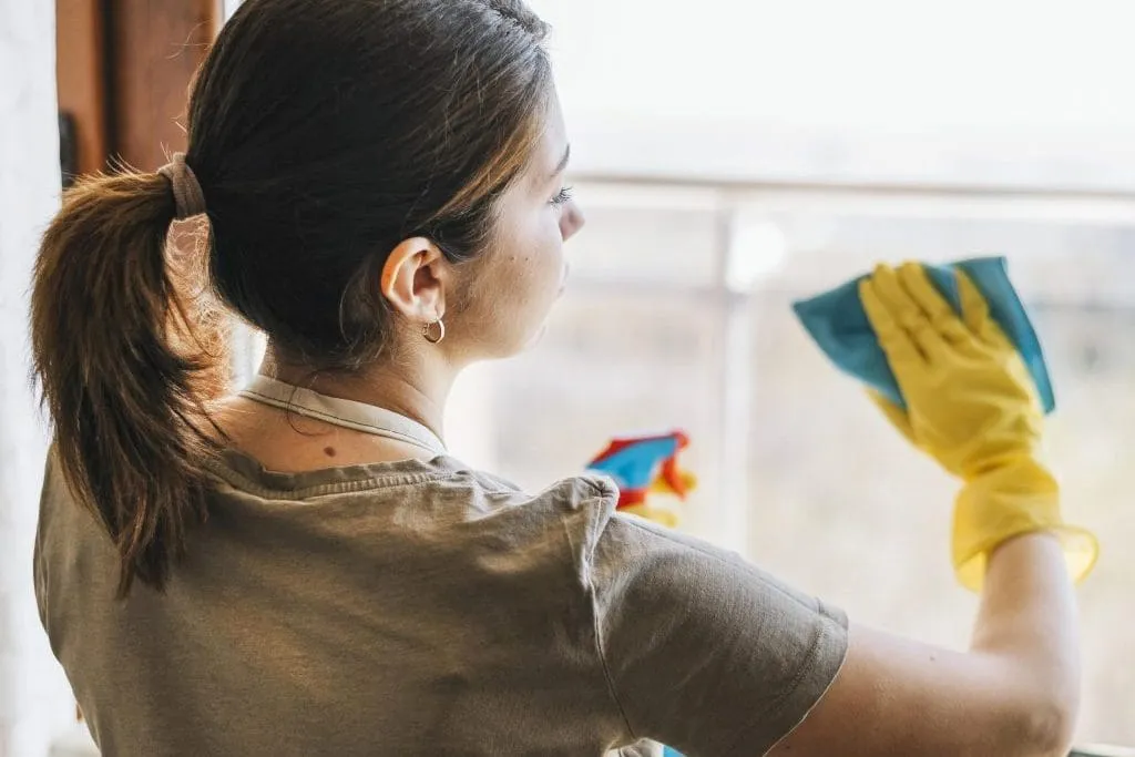 woman cleaning window