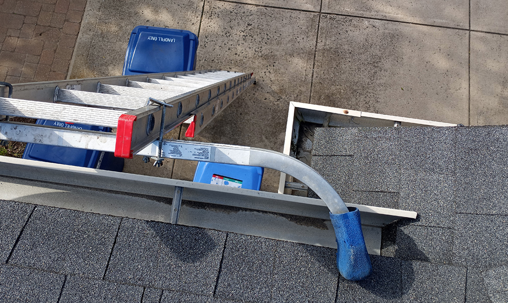 picture showing ladder leaning against gutter