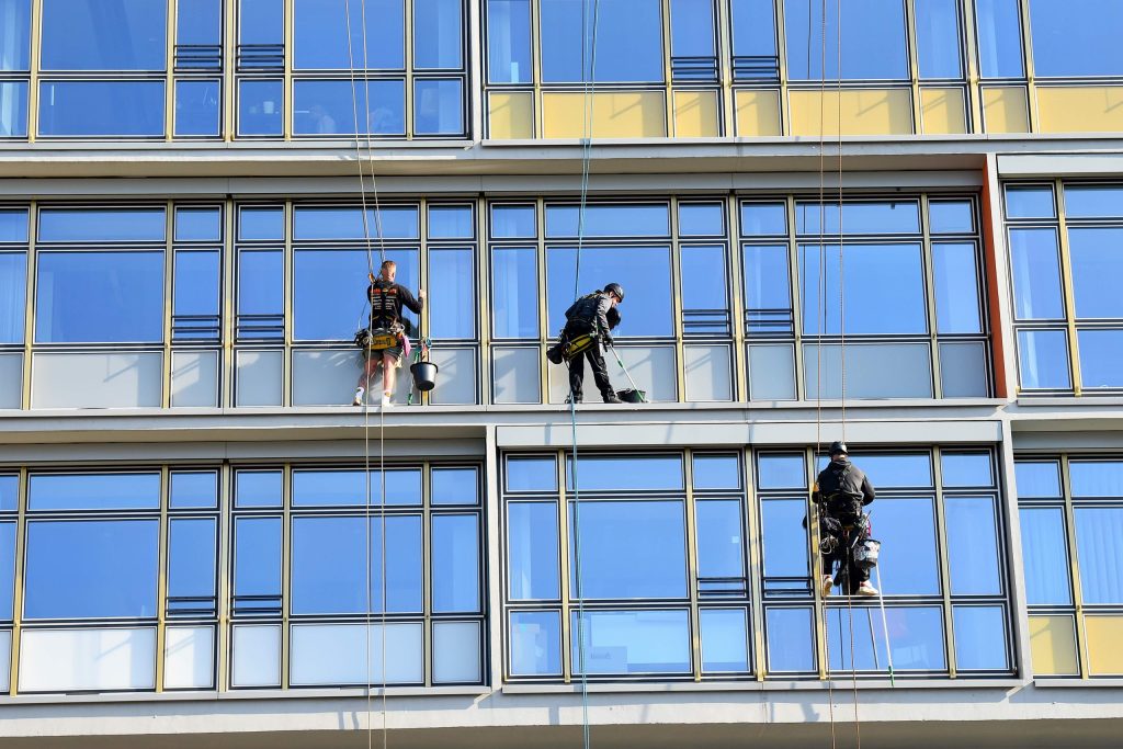 men working on modern building windows