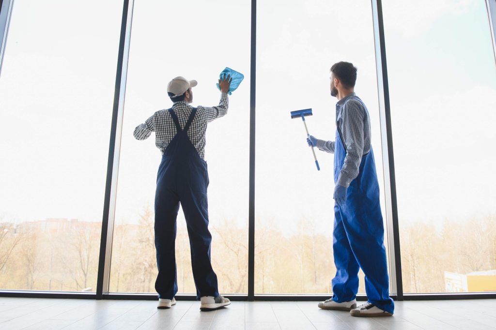 two men doing commercial window washing