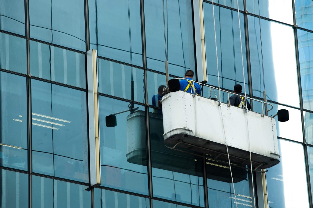 worker on crane window washing